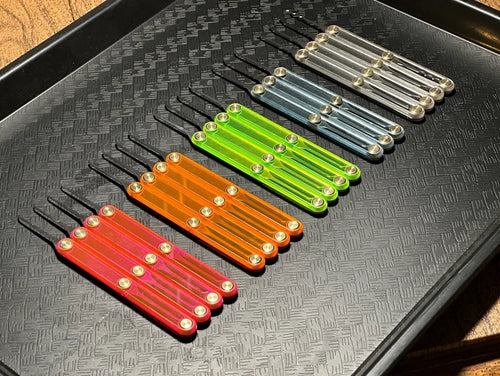 Set of colorful plastic tools on a textured black surface