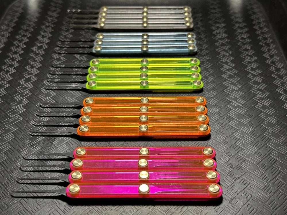 Set of colorful plastic tools on a textured black surface