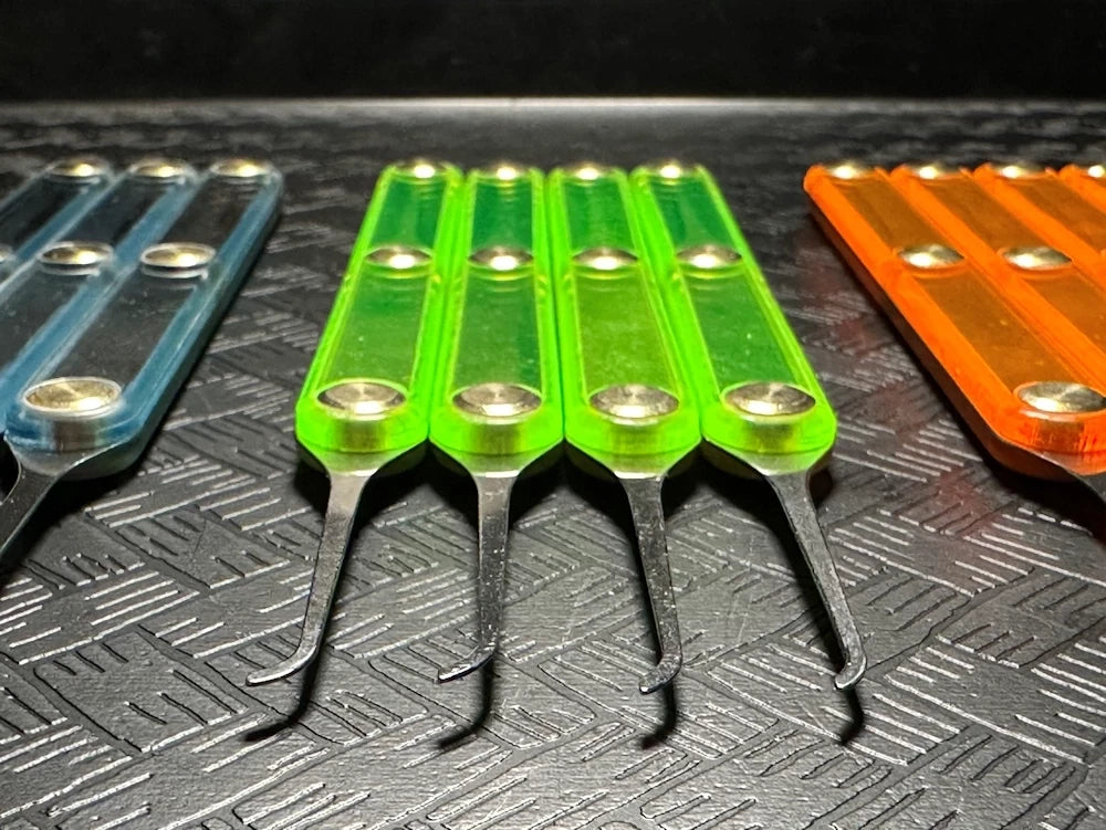 Set of colorful tools with metallic tips on a textured surface