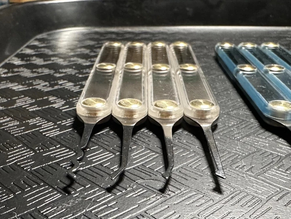 Set of metal tools on a textured black surface