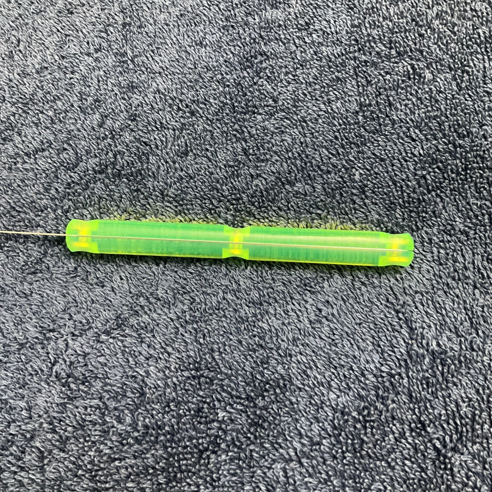 Green lockpick on a textured grey surface
