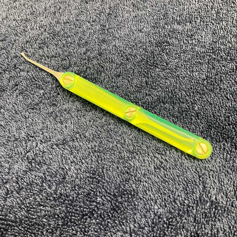 Green lockpick on a gray textured surface