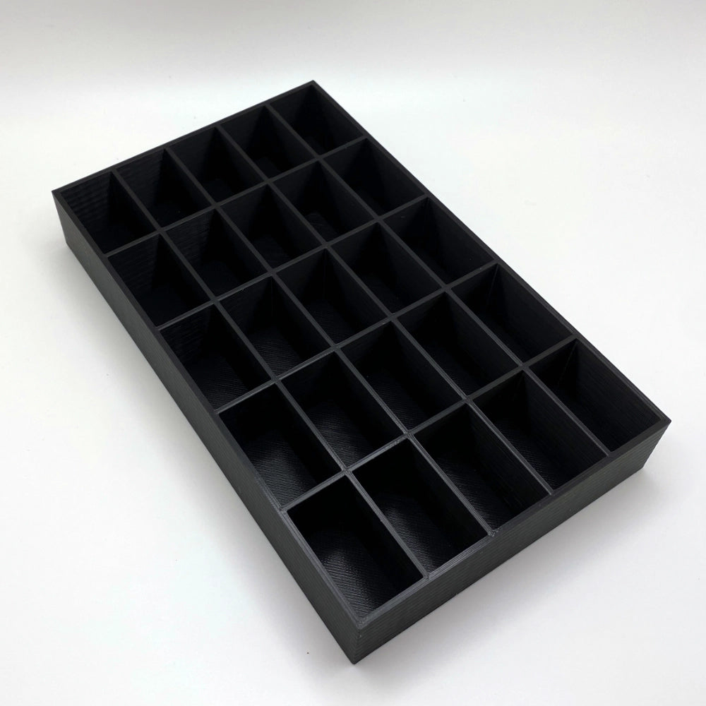 Black tray with compartments on a white background