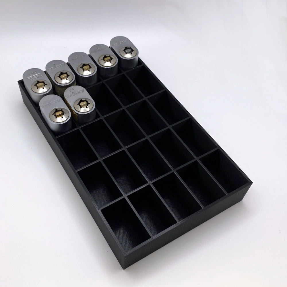 Black tray with compartments holding locks on a white background