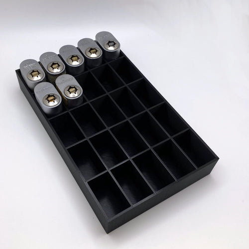 Black tray with compartments holding locks on a white background