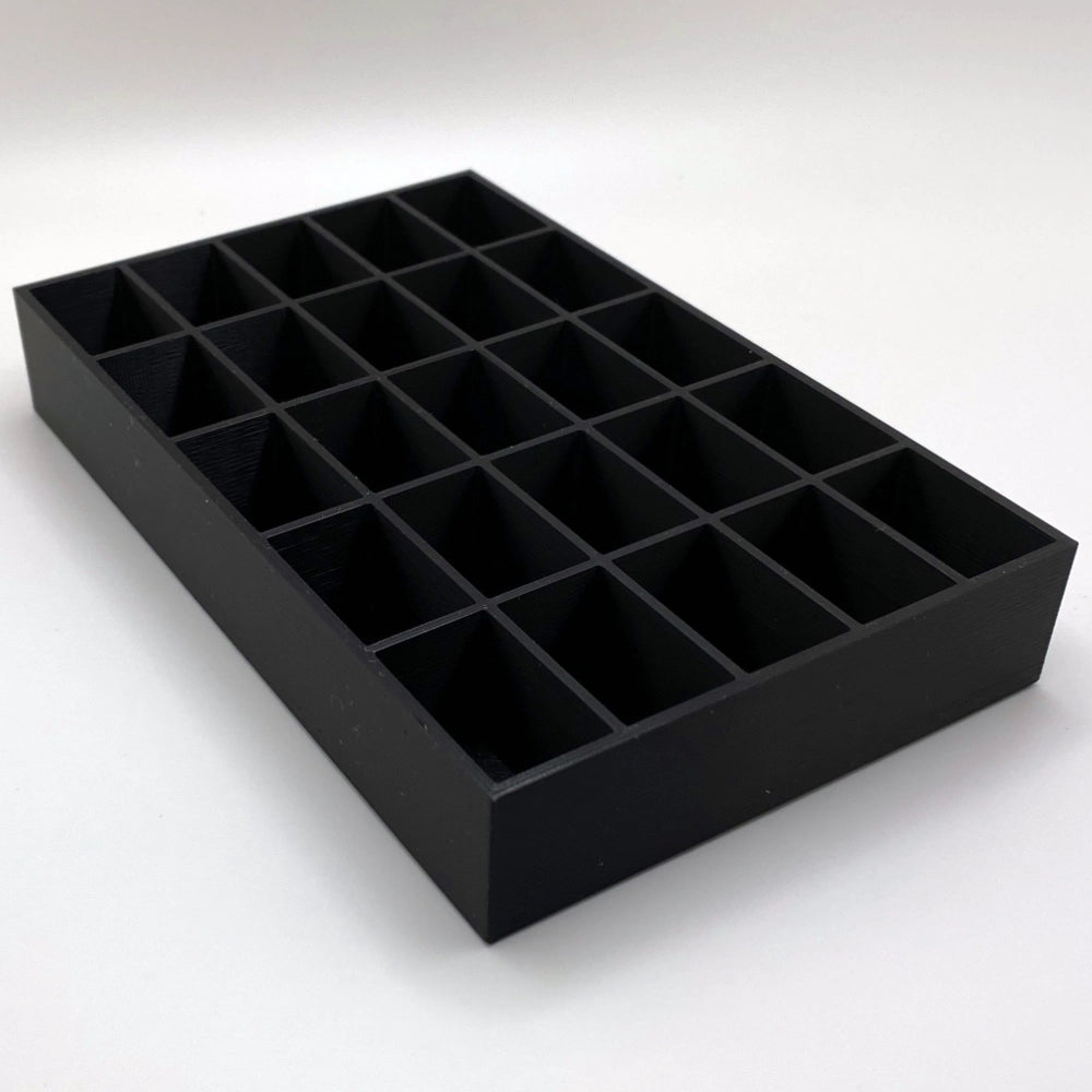 Black tray with compartments on a white background