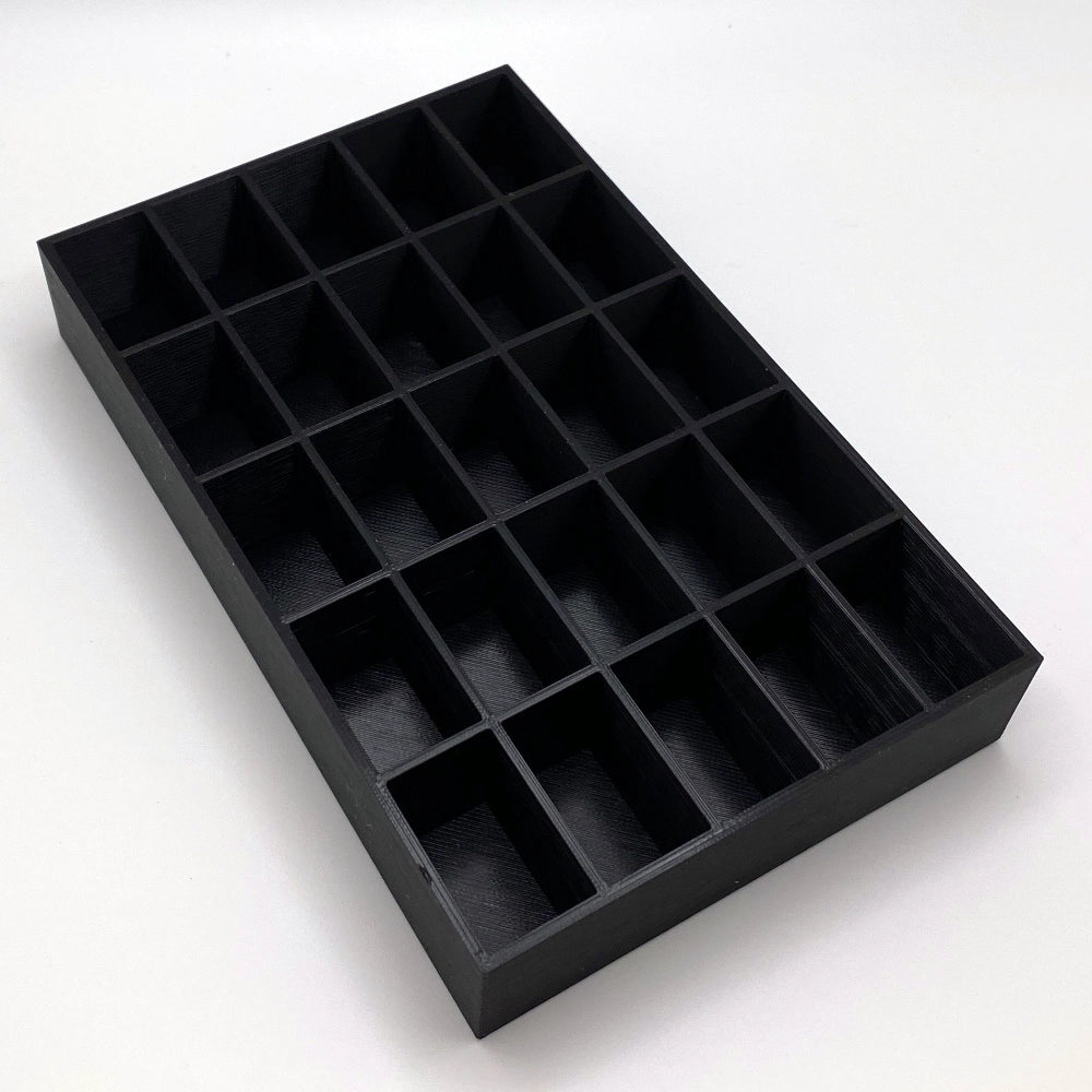 Black tray with compartments on a white background