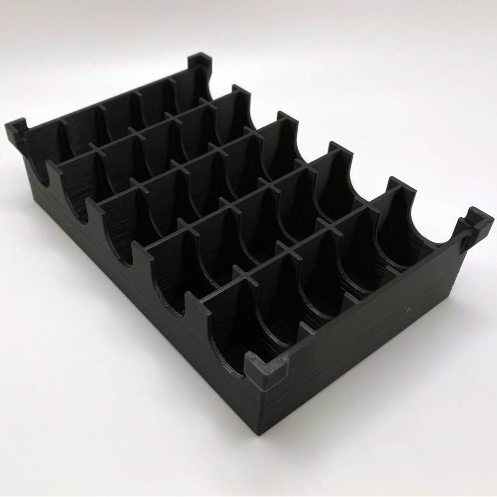Black plastic organizer with multiple compartments on a white background