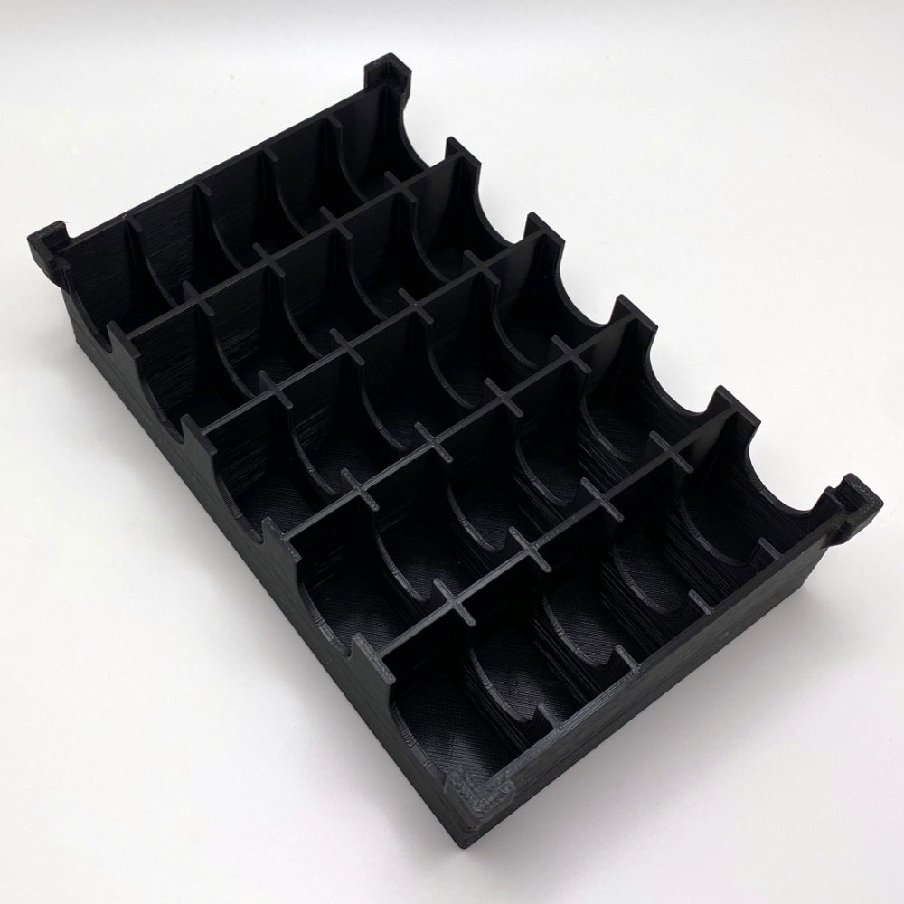 Black plastic component on a white background