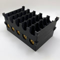 Black plastic component with multiple slots on a white background