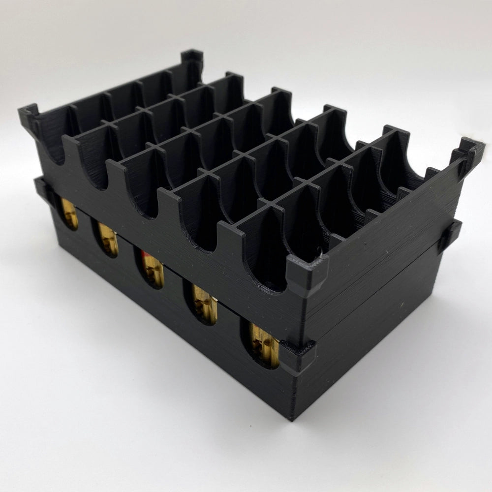 Black plastic component with multiple slots on a white background
