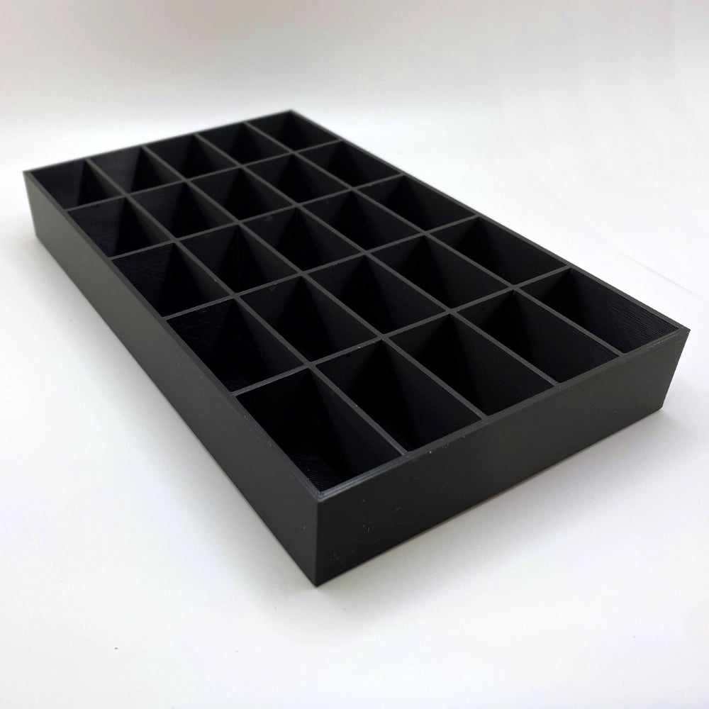 Black tray with compartments on a white background