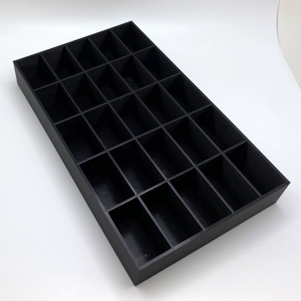 Black tray with compartments on a white background