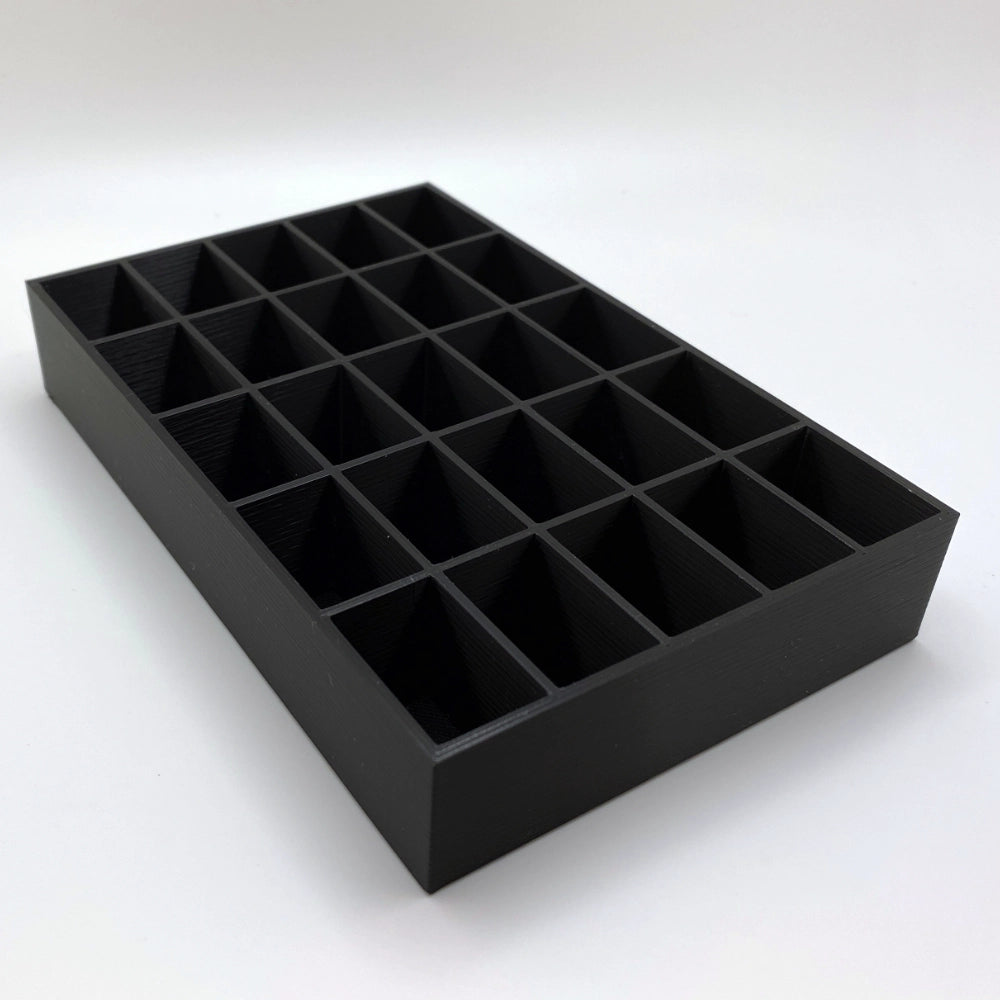 Black tray with multiple compartments on a white background