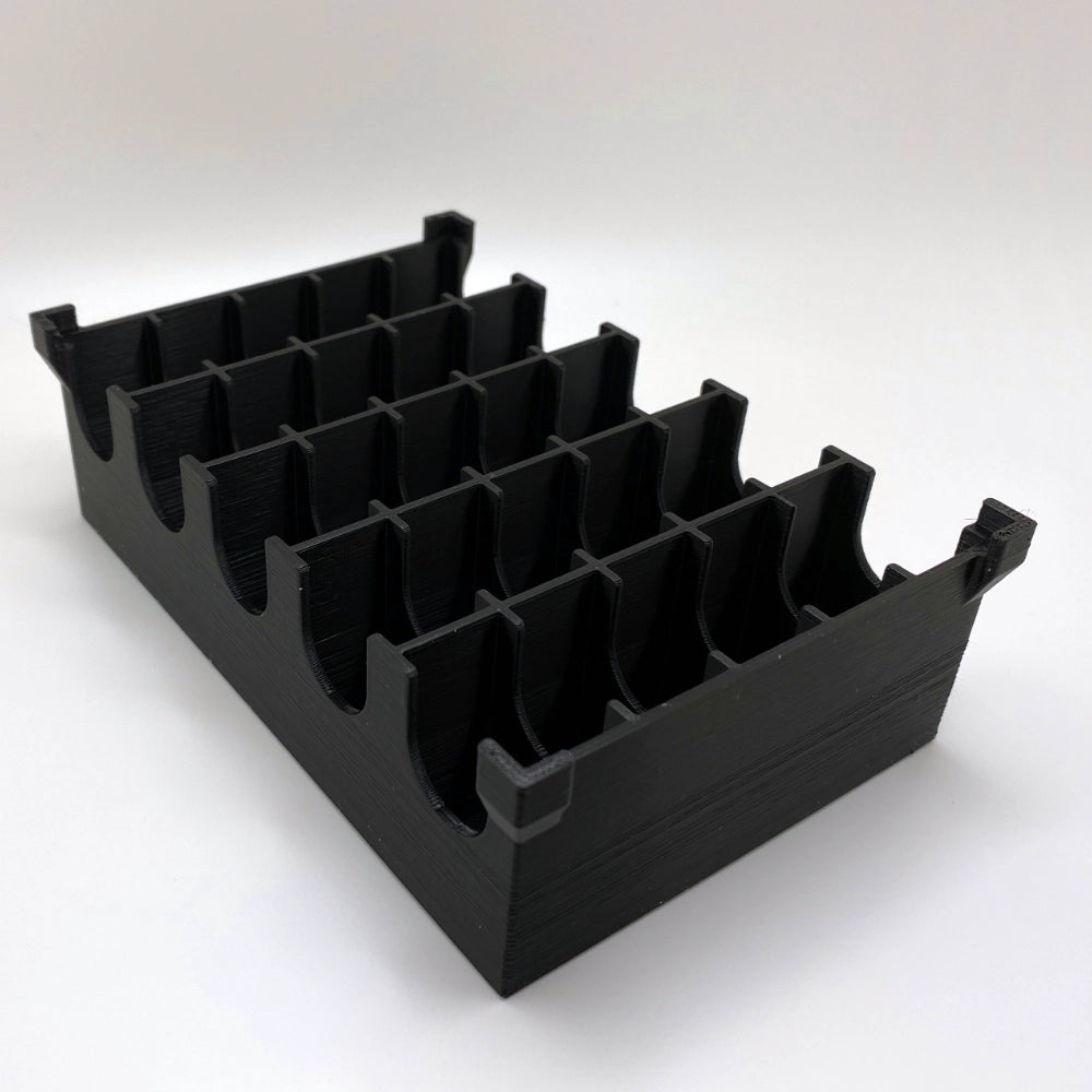 Black plastic component on a white background