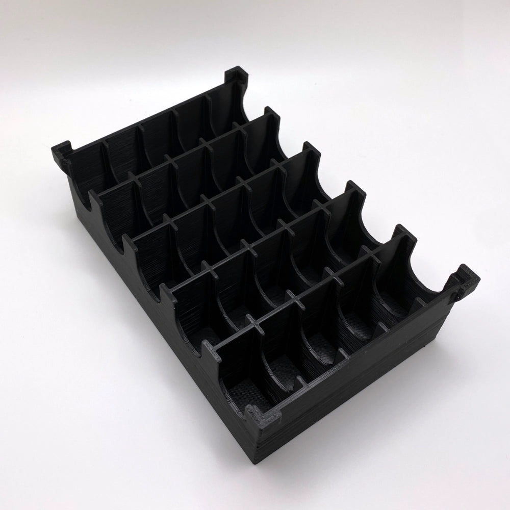 Black plastic component on a white background
