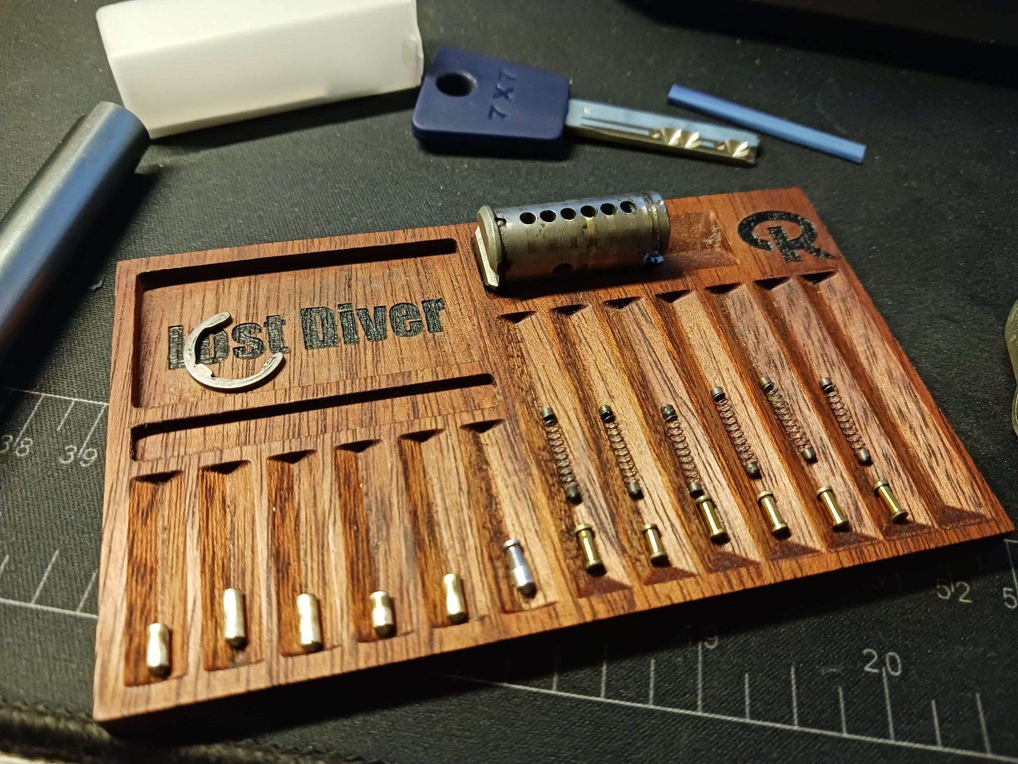 Wooden tool organizer with various tools on a black surface