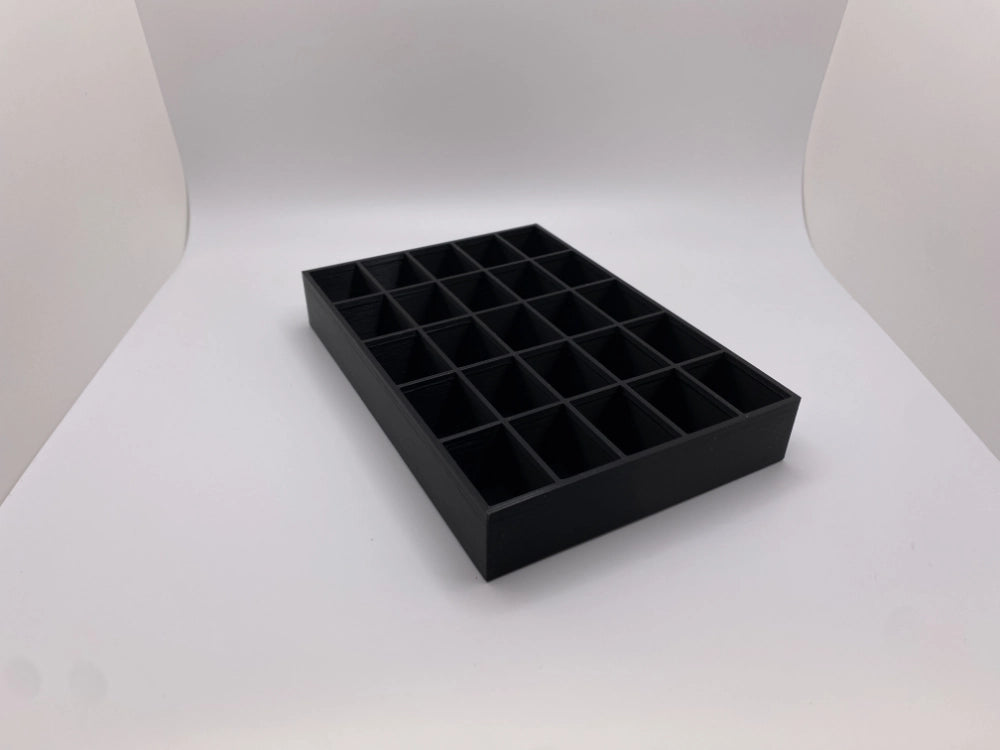 Black tray with compartments on a white background