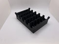 Black plastic component on a white background