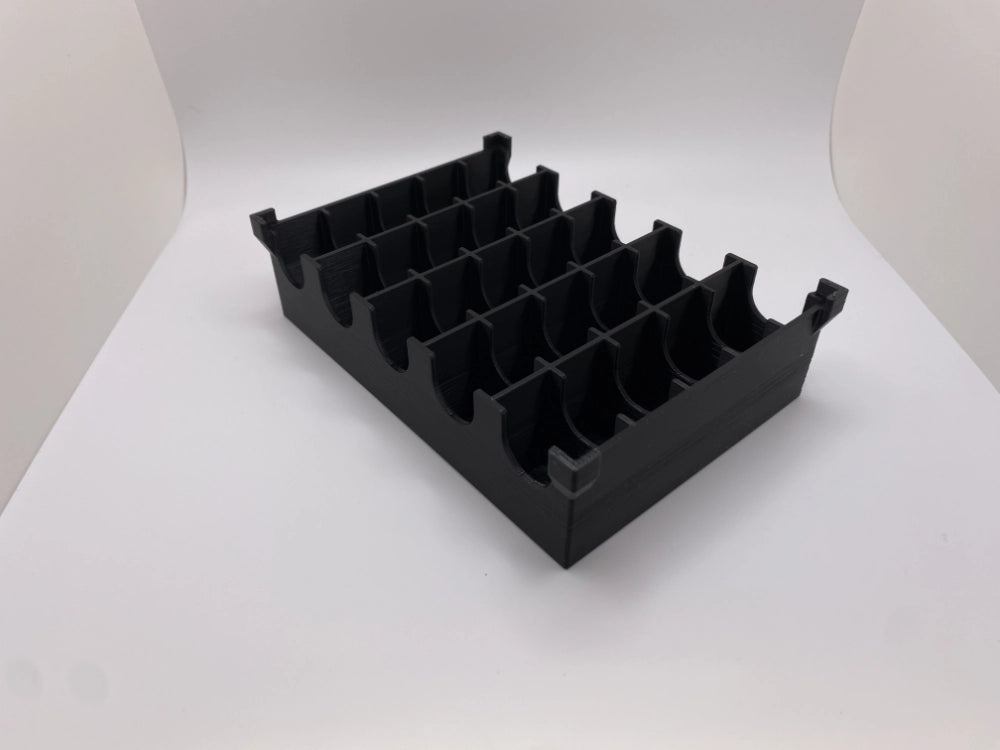 Black plastic component on a white background