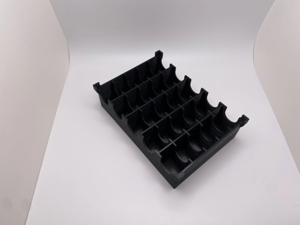 Black tray with compartments holding locks on a white background