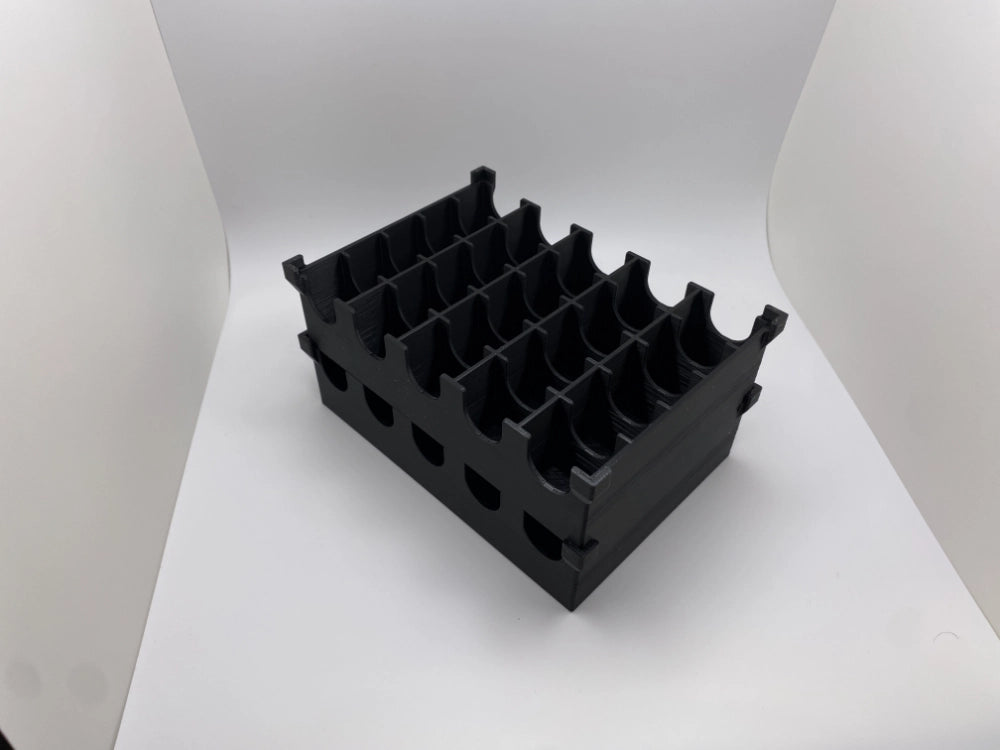Black plastic component on a white background