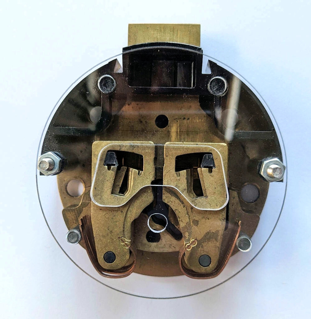 Mechanical component with brass and metal parts on a white background