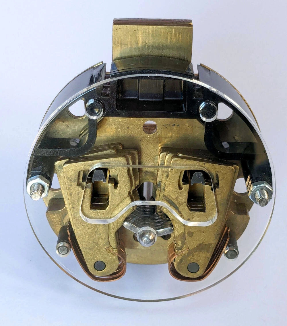 Mechanical lock component with brass and metal parts on a white background
