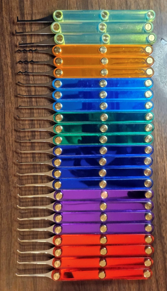 Set of colorful lockpicks on a wooden surface