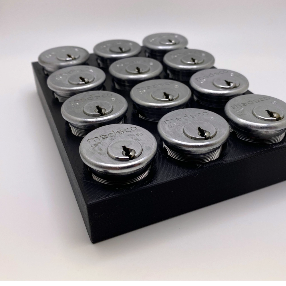 Set of silver locks on a black tray with a white background