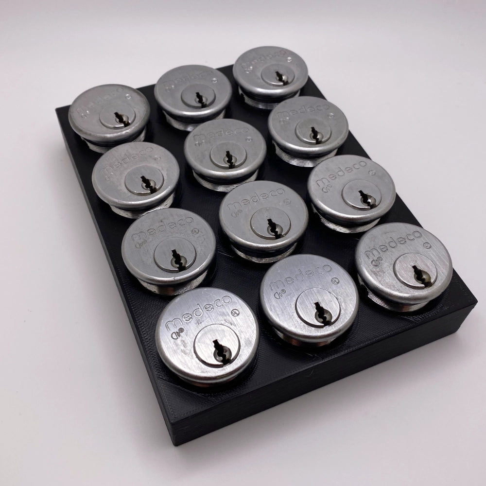 Set of silver locks on a black tray against a white background
