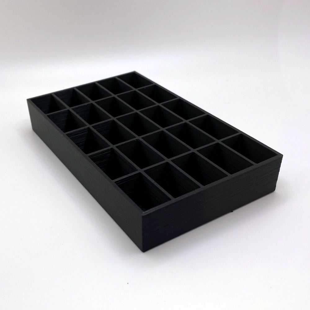 Black tray with compartments on a white background