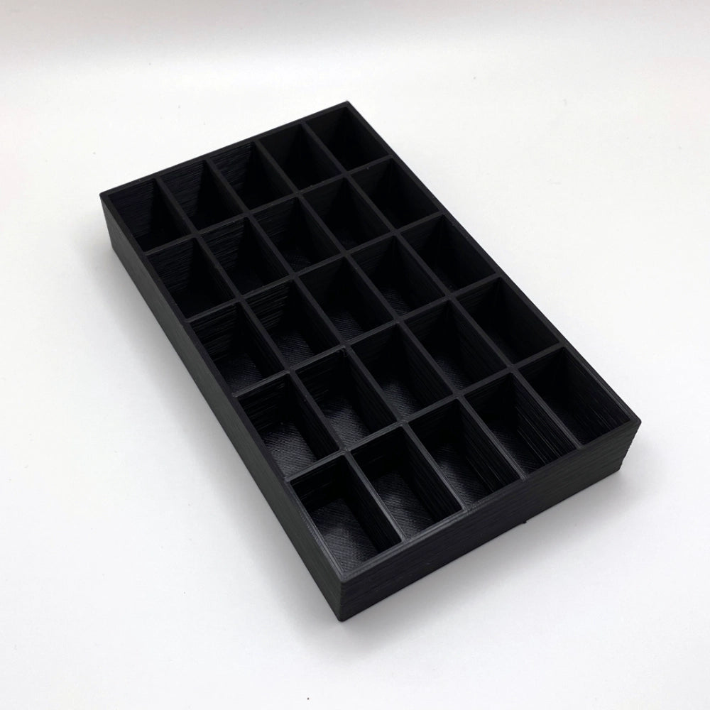 Black tray with compartments on a white background