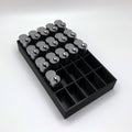 Black tray with compartments holding locks on a white background