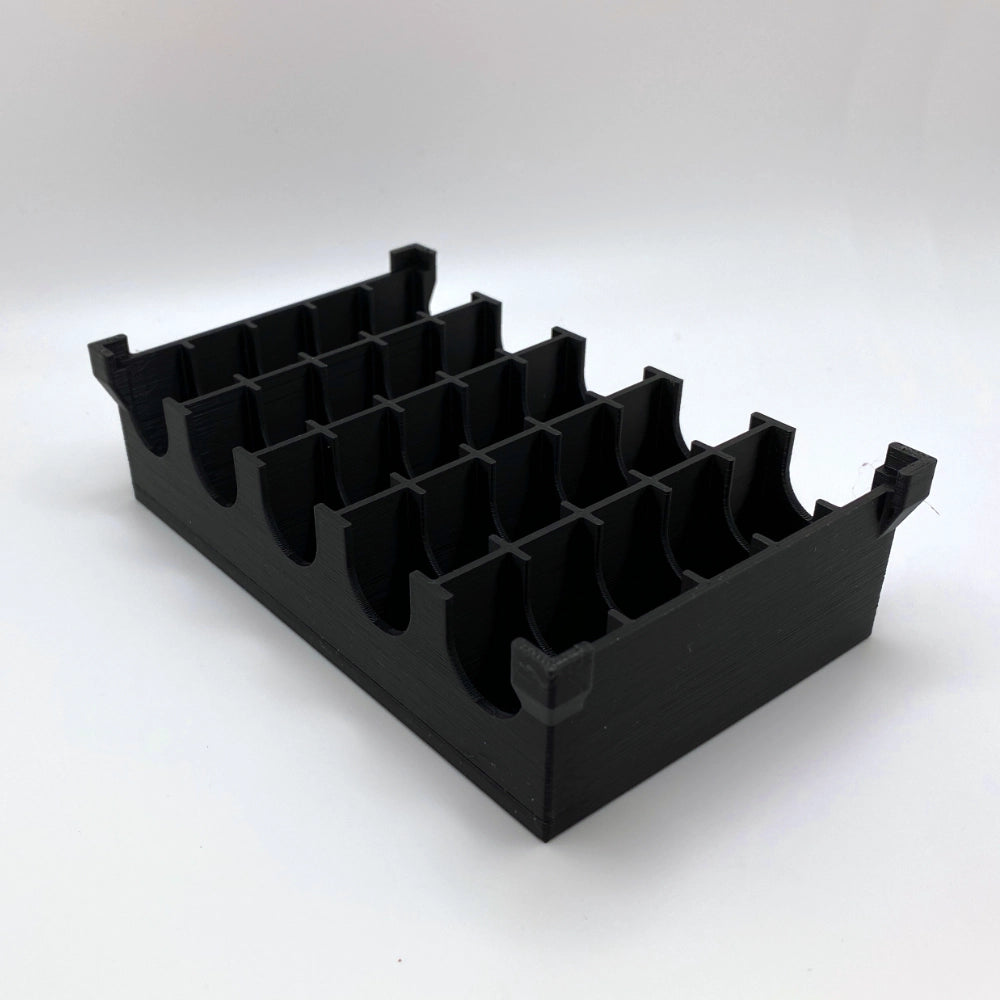 Black plastic component on a white background