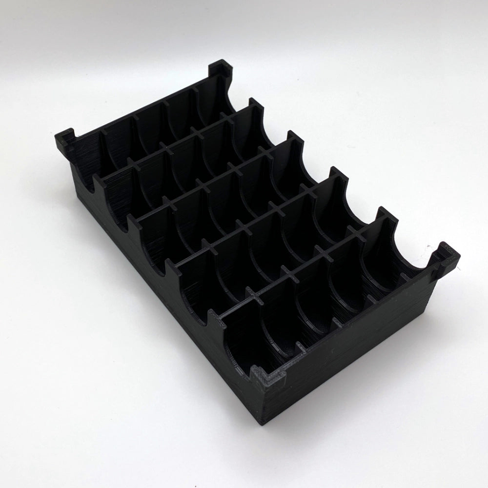 Black plastic component on a white background