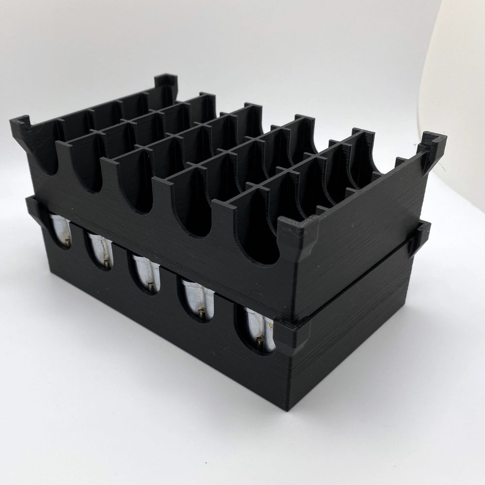 Black plastic holder with multiple compartments on a white background