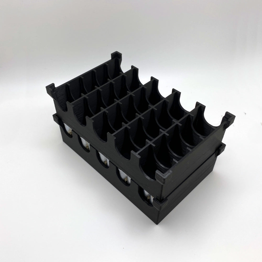 Black plastic component on a white background