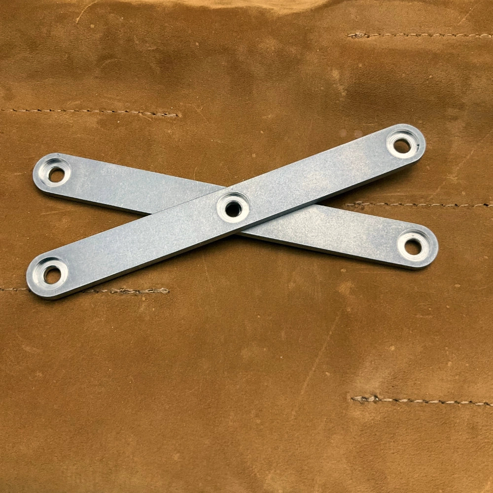 Metal handleson a brown leather surface