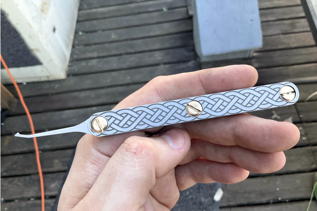hand holding a metal lockpick