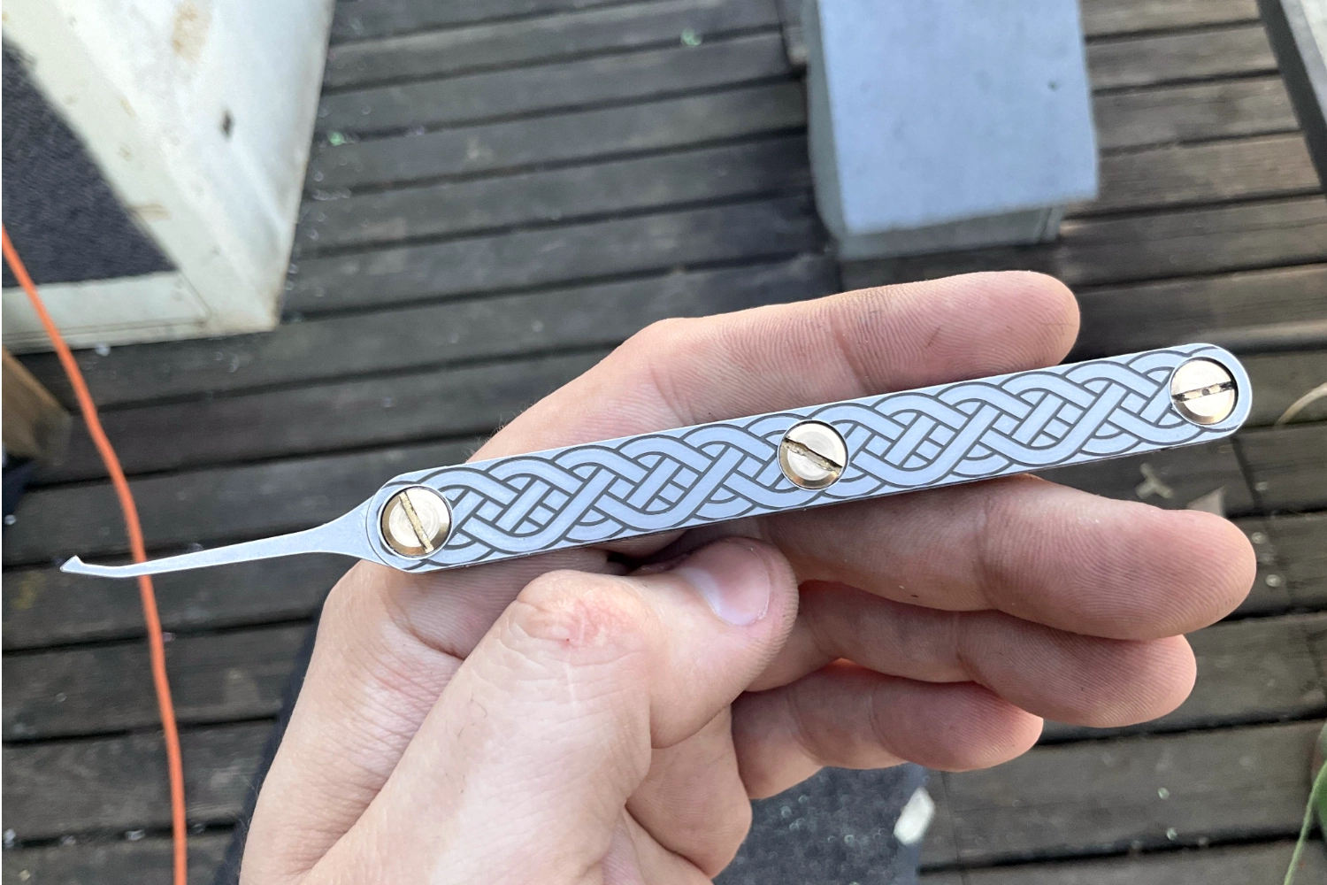 hand holding a metal lockpick